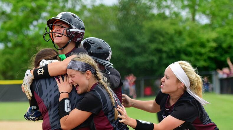 Members of the Lebanon Warriors celebrate Wednesday’s 14-13 win over Lakota West in a Division I regional semifinal at Centerville. NICK GRAHAM/STAFF