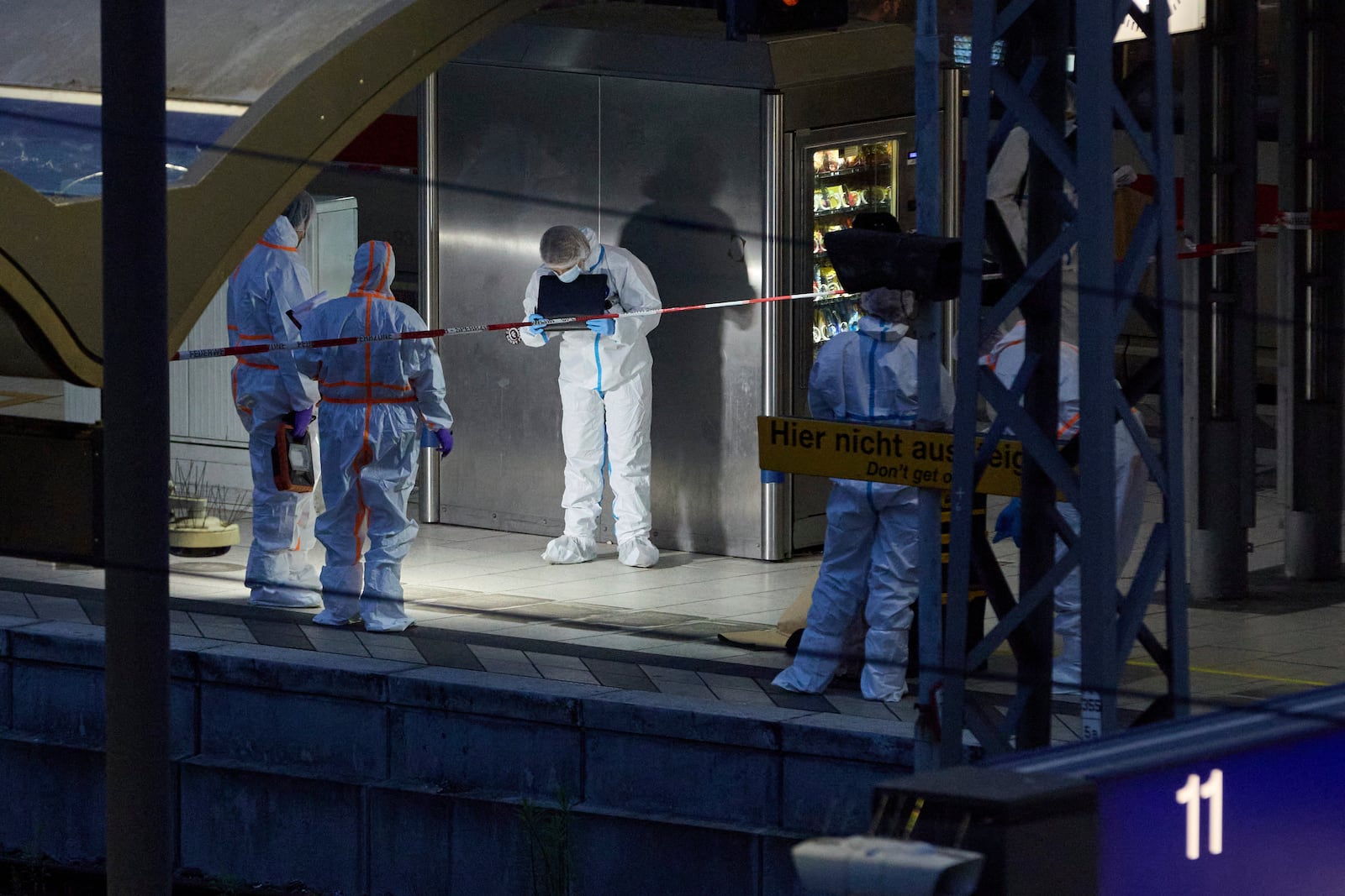 Investigators work at Hamburg, Germany's Central Station on Friday, May 23, 2025, after several people were injured in a knife attack. (Georg Wendt/dpa via AP)