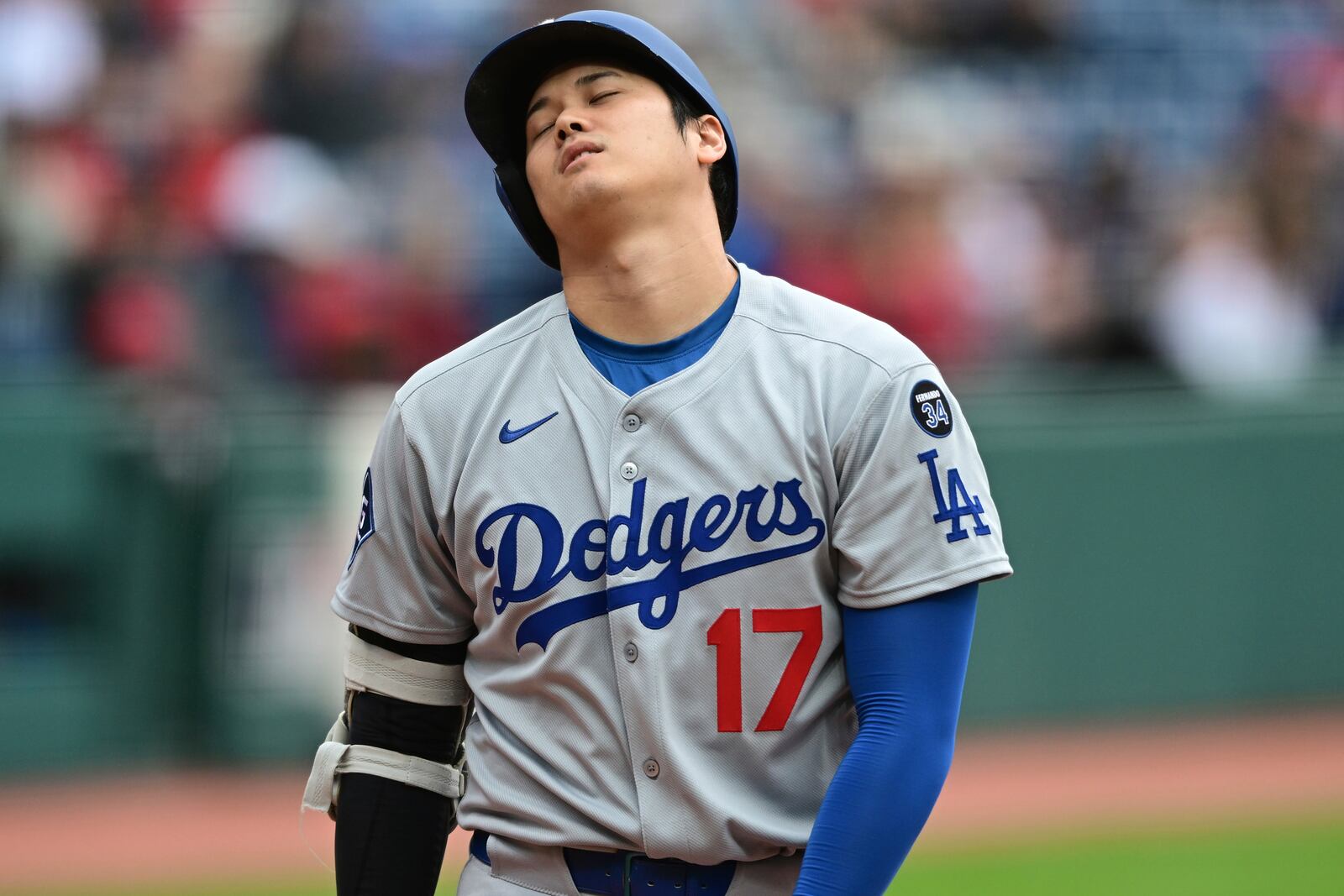 Los Angeles Dodgers' Shohei Ohtani reacts after hitting a foul ball during the first inning of a baseball game against the Cleveland Guardians, Wednesday, May 28, 2025, in Cleveland. (AP Photo/David Dermer)