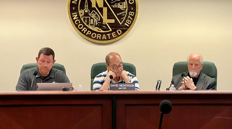 Former Acting New Lebanon Village Manager Rob Anderson, left, listens to resident comments during a regular meeting on May 7, 2024, along with Mayor David Nickerson, center, and Acting Law Director Michael McNamee. AIMEE HANCOCK/STAFF