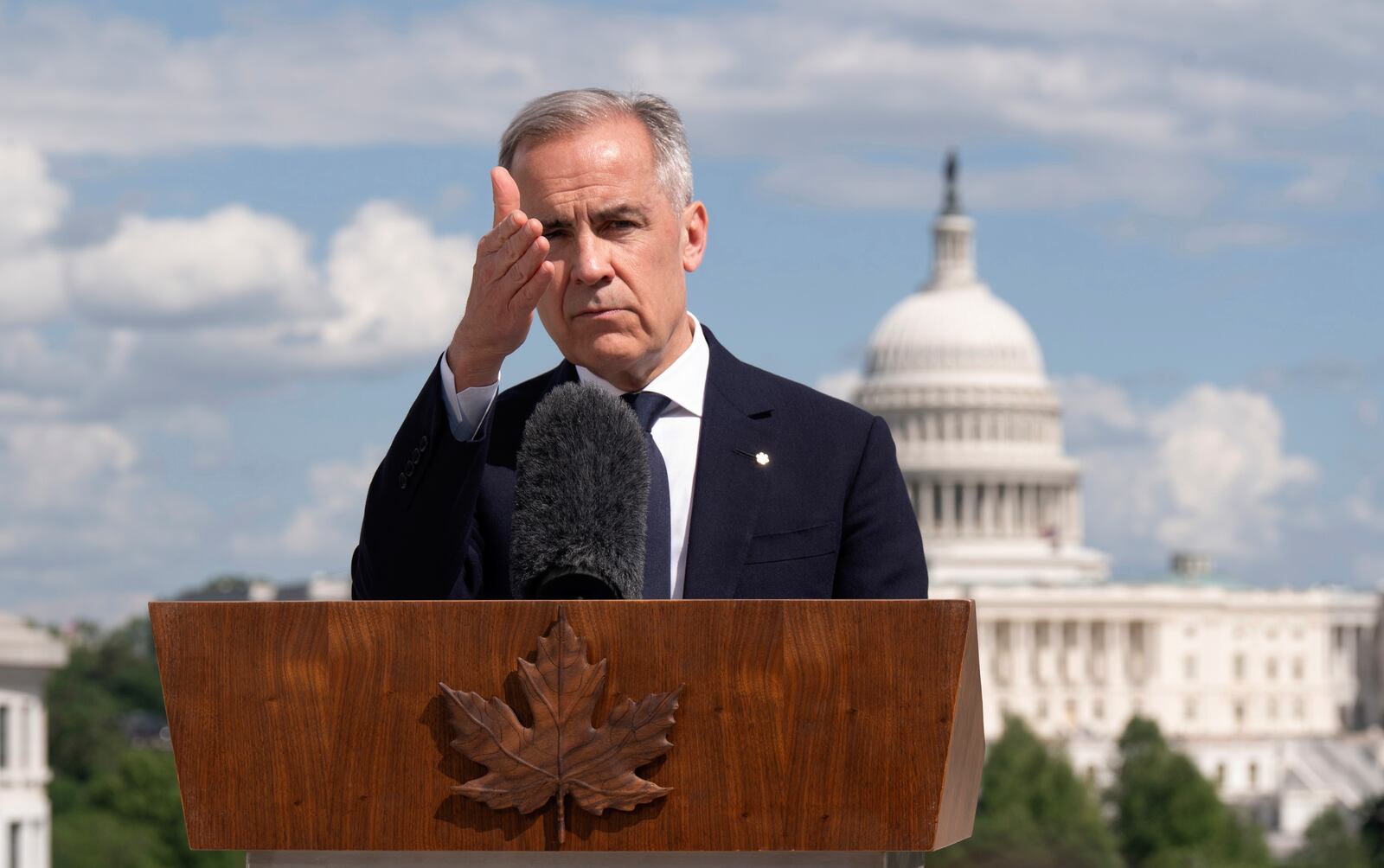 Canada's Prime Minister Mark Carney gestures to a reporter as he takes questions during a news conference at the Canadian embassy in Washington, Tuesday, May 6, 2025. (Adrian Wyld/The Canadian Press via AP)