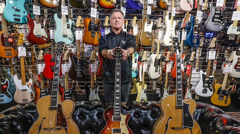 Hauer Music president, Jim Hauer show-off three of his stores most expensive guitars. Hauer Music is celebrating 85 years in the Dayton area. Many famous and not so famous musicians have walked through the doors. The store is located at 528 Miamisburg-Centerville Road in Centerville. JIM NOELKER/STAFF