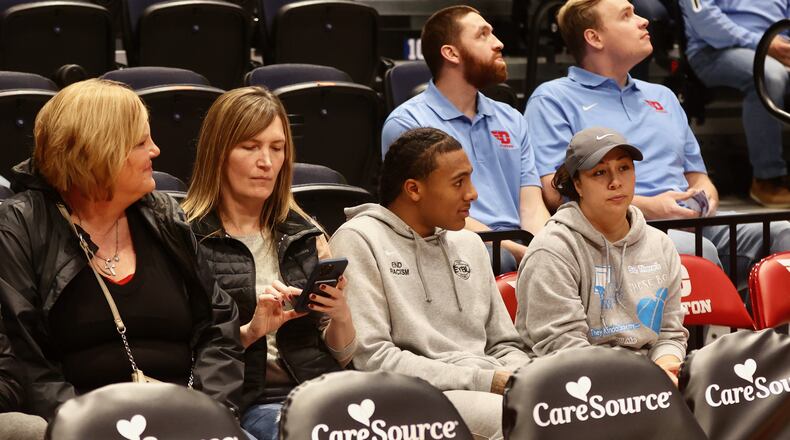 Durral Brooks, second from right, watches a Dayton game against SMU from behind the bench on Nov. 13, 2022, at UD Arena. David Jablonski/Staff