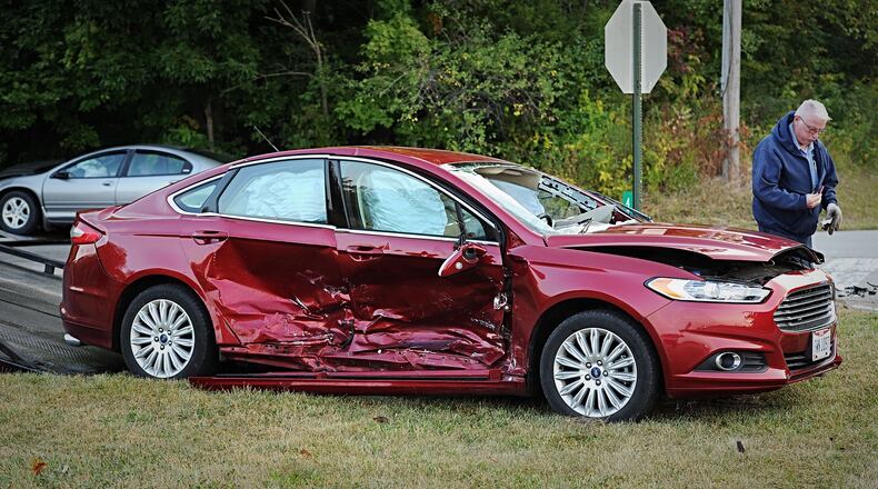 A two-vehicle crash at West National and Aullwood roads in Butler Twp. trapped two people and resulted in minor injuries. STAFF PHOTO / MARSHALL GORBY