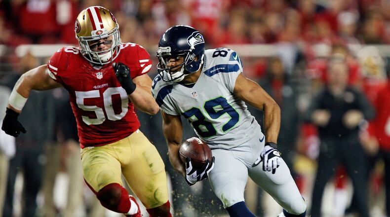 SANTA CLARA, CA - NOVEMBER 27: Wide receiver Doug Baldwin #89 of the Seattle Seahawks takes a pass for a 24-yard gain against linebacker Chris Borland #50 of the San Francisco 49ers in the first quarter on November 27, 2014 at Levi’s Stadium in Santa Clara, California. The Seahawks won 19-3. (Photo by Brian Bahr/Getty Images)