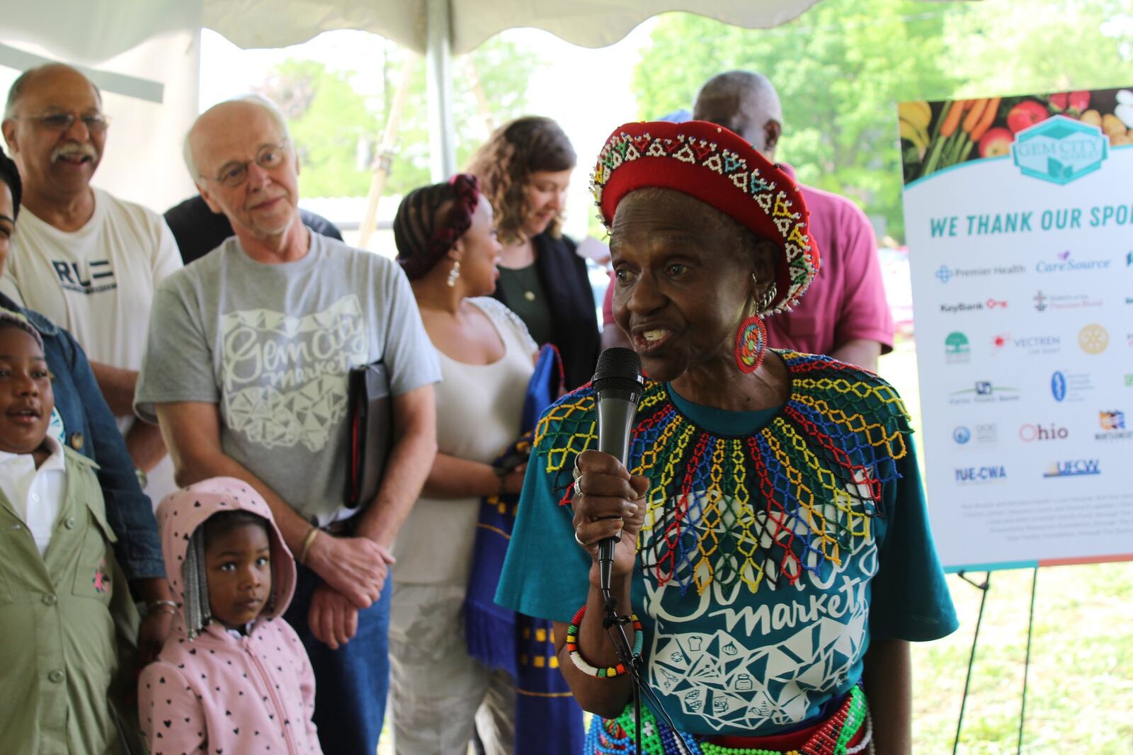 Mama Nozipo Glenn talks about a lack of access to healthy and fresh foods in northwest Dayton during Wednesday’s unveiling of the home of the Gem City Market food co-op. CORNELIUS FROLIK / STAFF