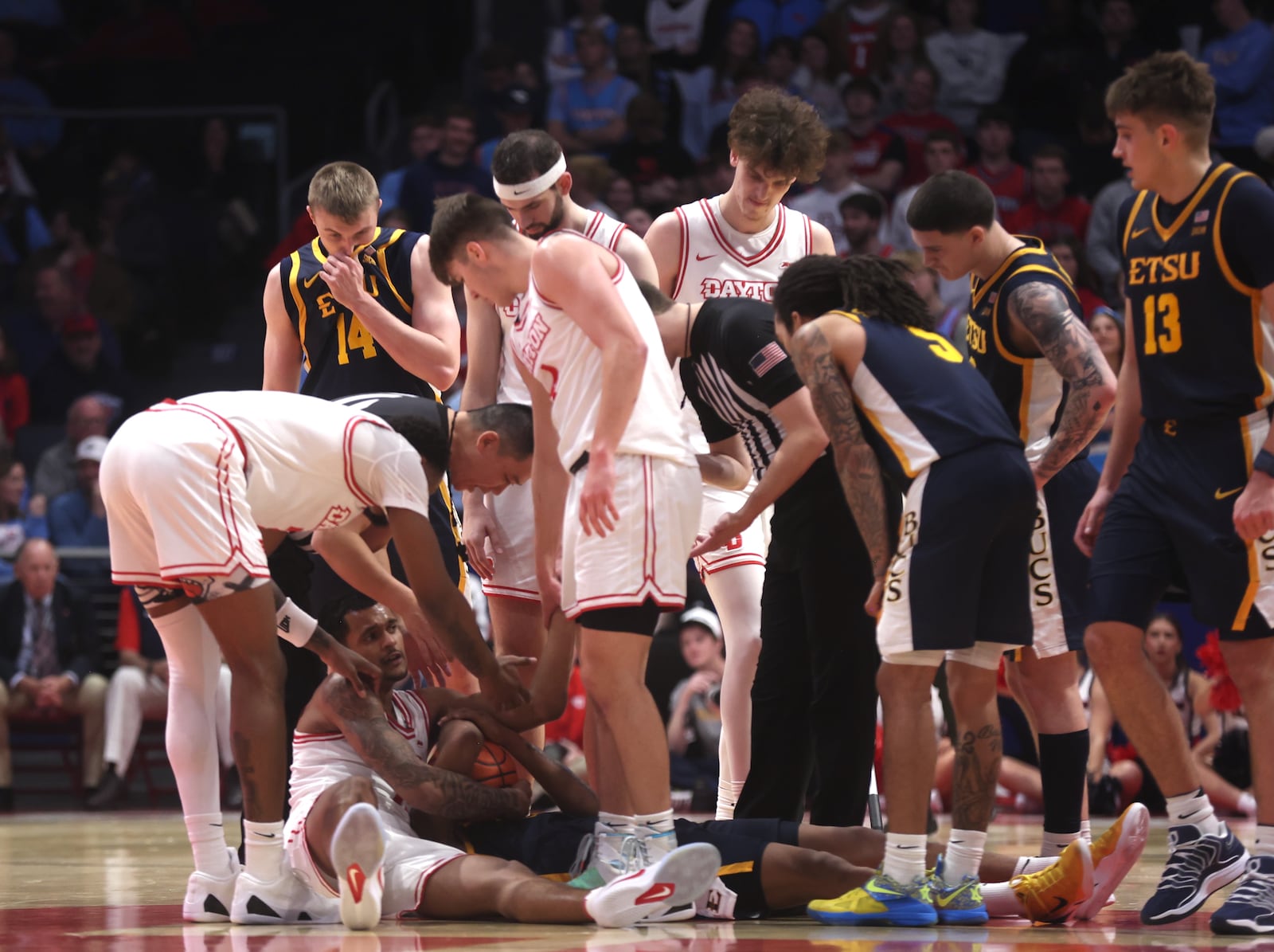 Dayton and East Tennessee State gather after a jump ball on Tuesday, Dec. 2, 2025, at UD Arena. David Jablonski/Staff