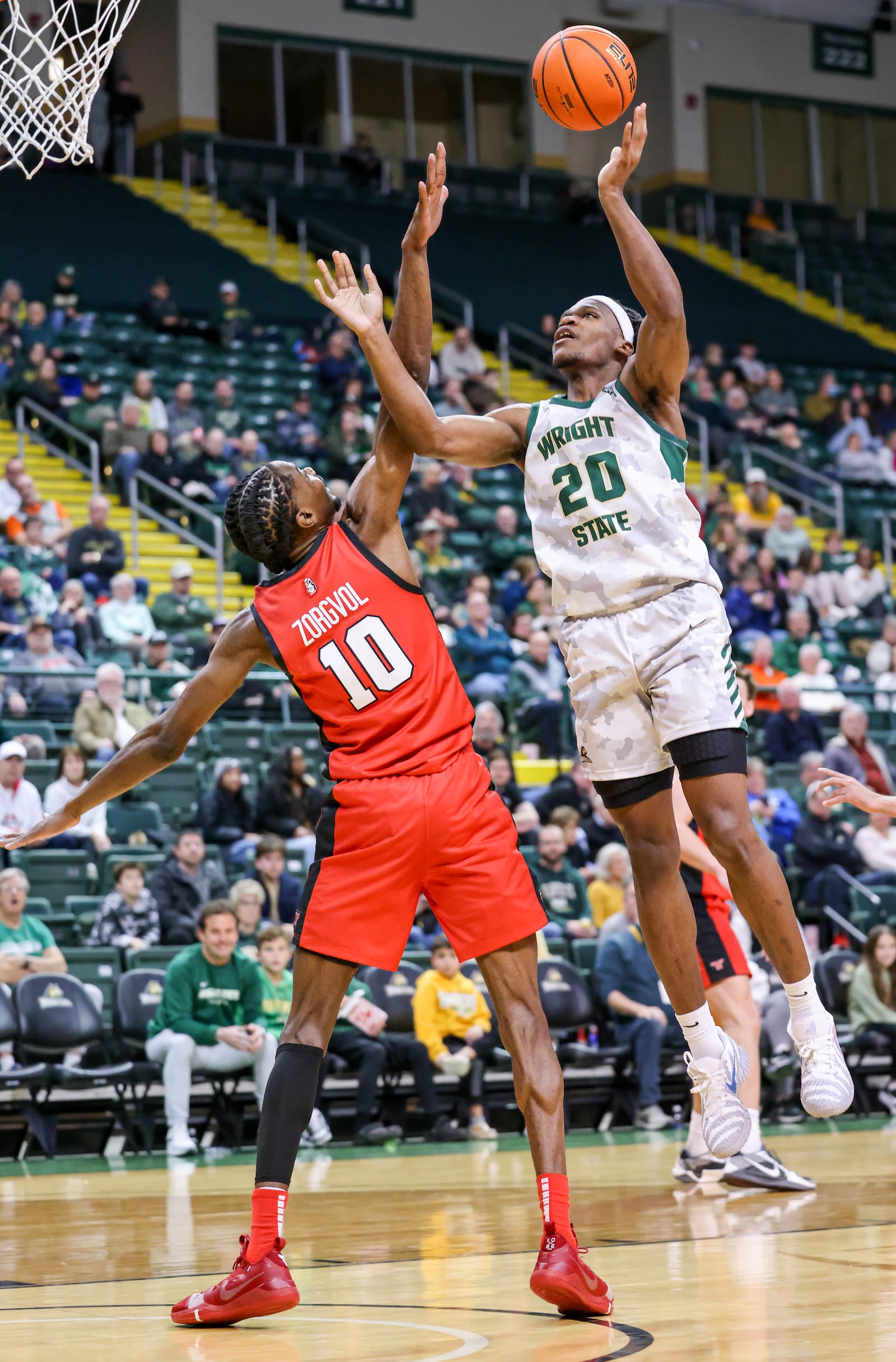 Wright State sophomore guard Andrea Holden shoots with pressure from Youngstown State's Imanuel Zorgvol during a Horizon League game on Thursday, Jan. 15 at Ervin J. Nutter Center in Fairborn. BRYANT BILLING/STAFF