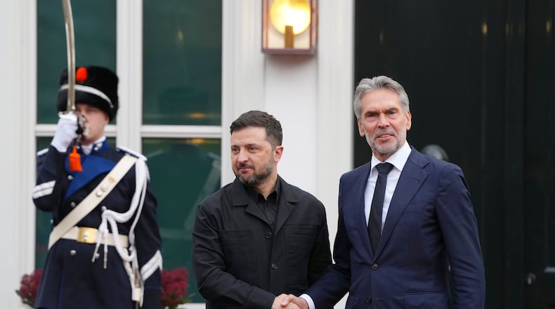 Dutch Prime Minister Dick Schoof, right, welcomes Ukraine's President Volodymyr Zelenskyy in The Hague, Netherlands, Tuesday, Dec. 16, 2025. (AP Photo/Peter Dejong)