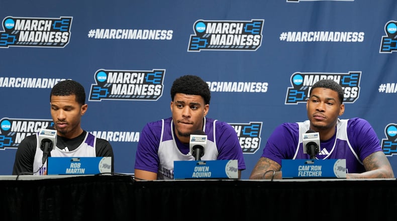 From left to right, High Point guard Rob Martin, forward Owen Aquino and forward Cam'ron Fletcher listen during a news conference prior to the second round of the NCAA college basketball tournament Friday, March 20, 2026, in Portland, Ore. (AP Photo/Jenny Kane)