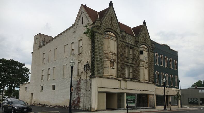 A Hamilton board voted Tuesday to allow demolition of the Treble Building, formerly the Third Street Department Store, at 216 S. Third Street (with the pointed roofline). But in a compromise, the CORE Fund, which owns it, agreed to mark the backs of facade stones and store them so they can be reassembled someday at either the same location or elsewhere. An attached building immediately to the south at 220 S. Third St., known as the Joffe Furniture building, is to be saved. MIKE RUTLEDGE/STAFF