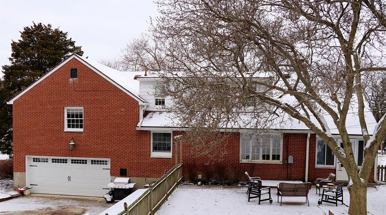 A wooden picket fence surrounds the terrace back yard. The rear-entry, 2-car garage is accessible from an alley and there is additional off-street parking.