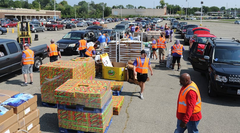 The Foodbank Drive-Thru operates drive-thru food distributions two days a week. During a distribution at the old Salem Mall in Trotwood in September, guests received fresh produce, proteins, grains and other products free of charge. MARSHALL GORBY\STAFF
MARSHALL GORBY\STAFF
