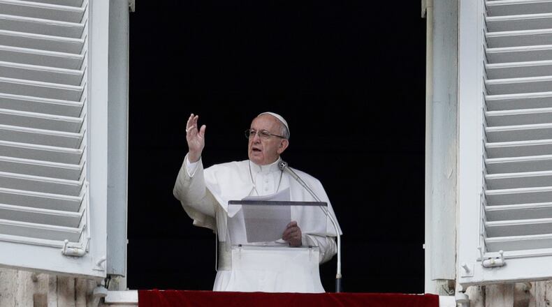 Pope Francis delivers a blessing during the Angelus prayer in St. Peter’s Square at the Vatican, Sunday, March 5, 2017. The pontiff has called on the faithful to consult the Bible with the same frequency as they might consult their smart phones for messages. (AP Photo/Gregorio Borgia)