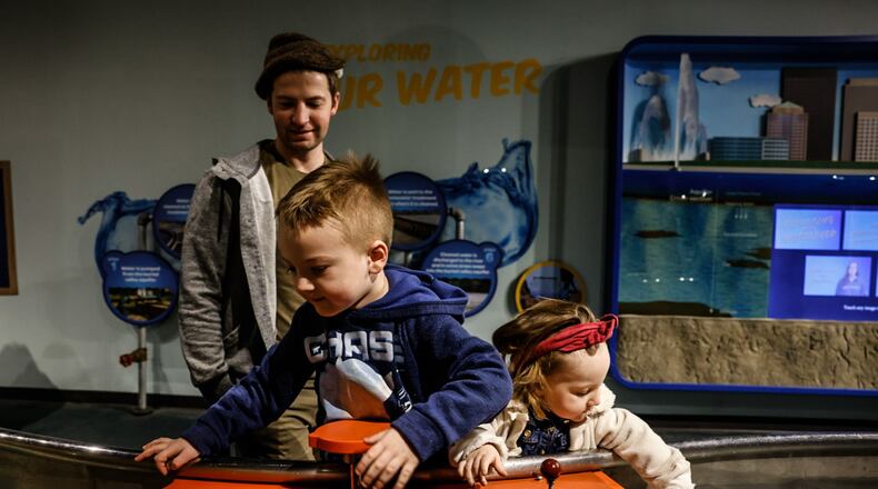 Michael and his siblings Henry and Ariel, from Lewisburg, play with the explore water feature at Boonshoft Museum of Discovery Tuesday January 23, 2024. JIM NOELKER/STAFF
