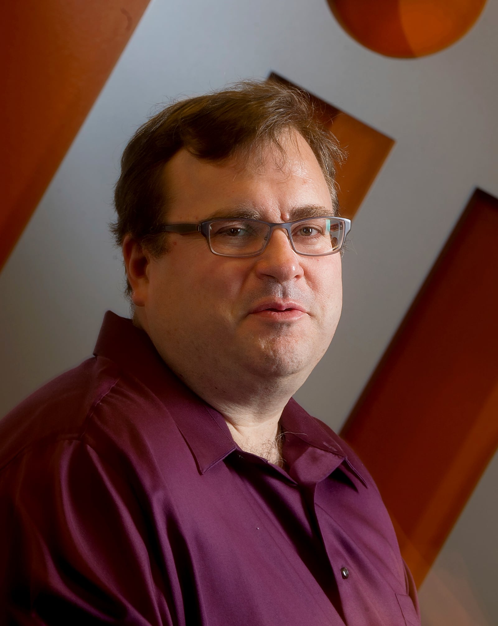 FILE - LinkedIn co-founder Reid Hoffman sits in the lobby of LinkedIn's Mountain View, Calif., headquarters on Tuesday, May 7, 2013. (AP Photo/Noah Berger, File)