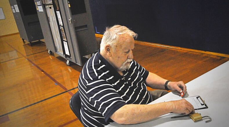 Steve Sullivan, polling location supervisor at Smith Elementary in Oakwood, prepares to return election materials. Due to the coronavirus pandemic,Due to the coronavirus pandemic, in-person voting was suspended Tuesday across Ohio until June 2. MARSHALL GORBYSTAFF
