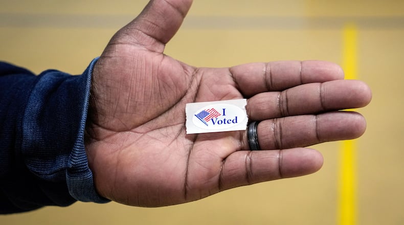 FILE - Sasha Dix holds his, "I voted," sticker after voting at T.C. Roberson High School on Election Day, Nov. 5, 2024, in Asheville, N.C. (AP Photo/Kathy Kmonicek, File)