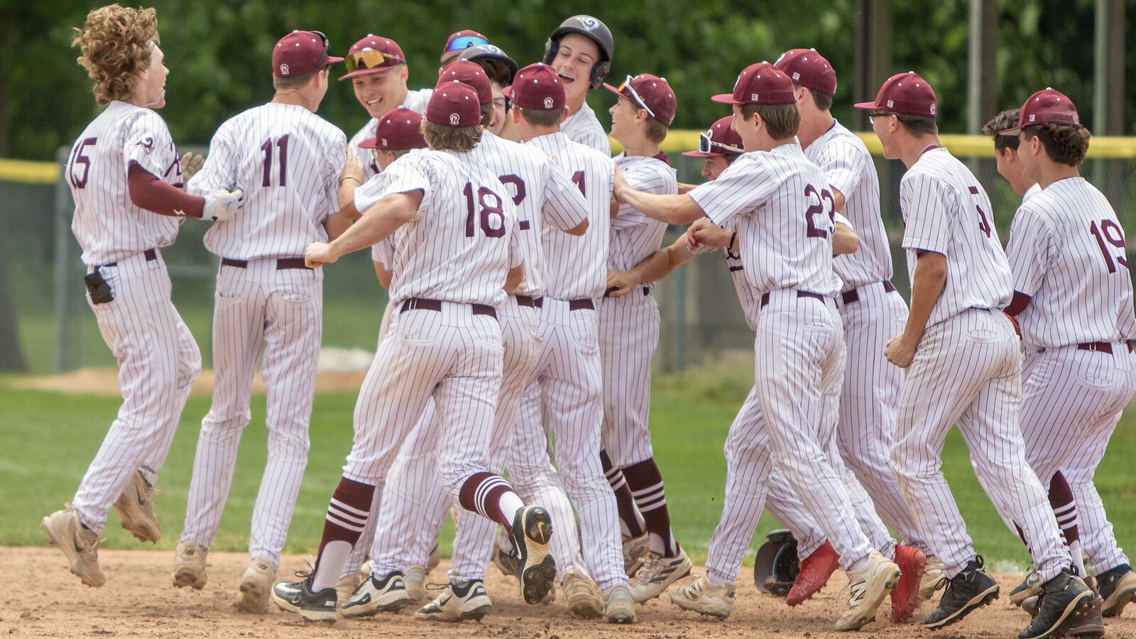 Ross celebrates Evan Gabbard's two-run walk-off single to win Saturday's Division III district title win at Bellbrook High School. Jeff Gilbert/CONTRIBUTED