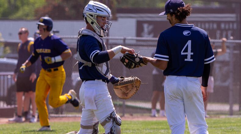Fairmont catcher Logan Adams gives the next baseball to pitcher Keegan Hart as Cincinnati Moeller's Clay Burdette jogs toward home after a three-run homer in the second inning Thursday in Lebanon. Jeff Gilbert/CONTRIBUTED