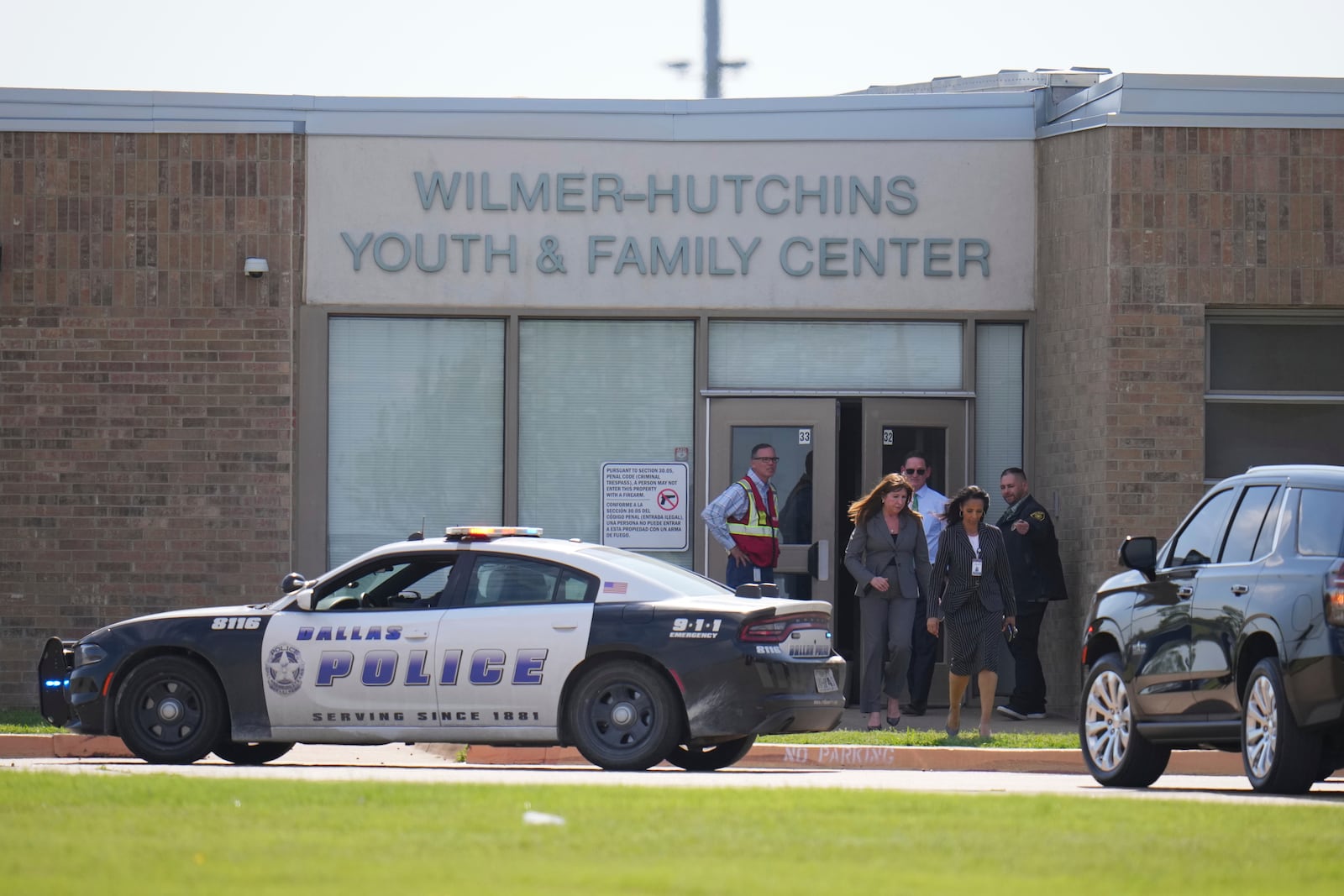 Superintendent Stephanie Elizalde, left center, exits the Wilmer-Hutchins High School youth and family center after authorities reported the campus had been secured following reports of a shooting, in Dallas, Tx., Tuesday, April 15, 2025. (AP Photo/Julio Cortez)