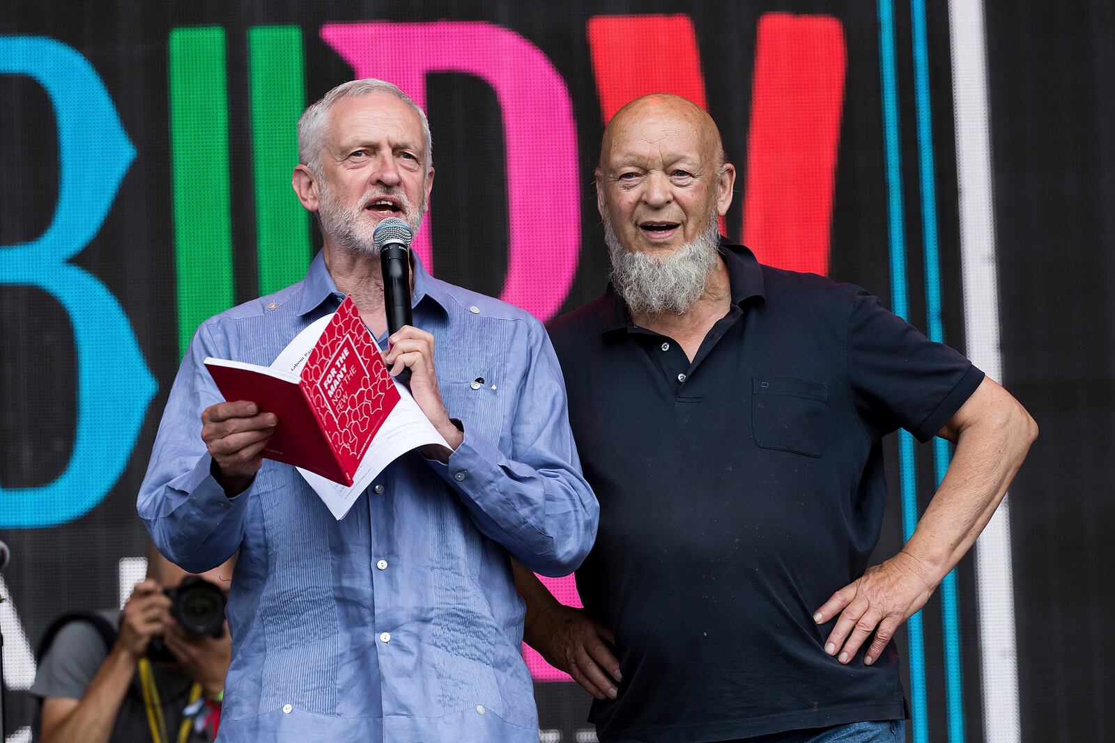 FILE - Britain's Labour Party leader Jeremy Corbyn, left, and organizer Michael Eavis appear onstage at the Glastonbury Festival at Worthy Farm, in Somerset, England, June 24, 2017. (Photo by Grant Pollard/Invision/AP, file)