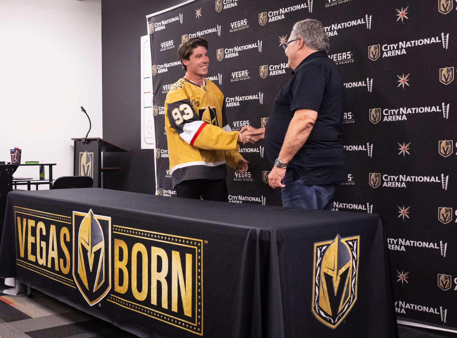 Newly acquired Golden Knights forward Mitch Marner, left, shakes hands with Golden Knights general manager Kelly McCrimmon during a press conference at City National Arena on Tuesday, July 1, 2025, in Las Vegas. (Chase Stevens/Las Vegas Review-Journal via AP)