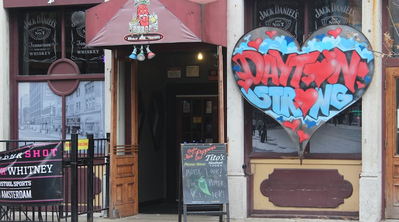 Six months after a 24-year-old Bellbrook man killed nine people in the Oregon District during the worst mass shooting in Ohio history, literal signs of strength, appreciation, resilience and the determination to “do something” about gun violence can be found throughout the historic neighborhood. "The Dayton Strong" sign hangs outside of Ned Peppers. AMELIA ROBINSON/STAFF
