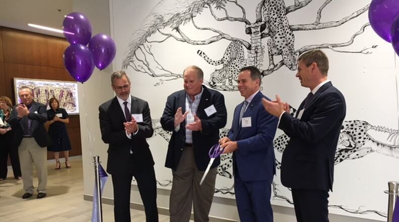 The ribbon is cut: NuVasive and West Carrollton officials open the new NuVasive production site on Liberty Lane. THOMAS GNAU/STAFF