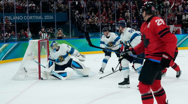 Canada's Nathan MacKinnon (29) scores his side's third goal during a men's ice hockey semifinal game between Canada and Finland at the 2026 Winter Olympics, in Milan, Italy, Friday, Feb. 20, 2026. (AP Photo/Petr David Josek)