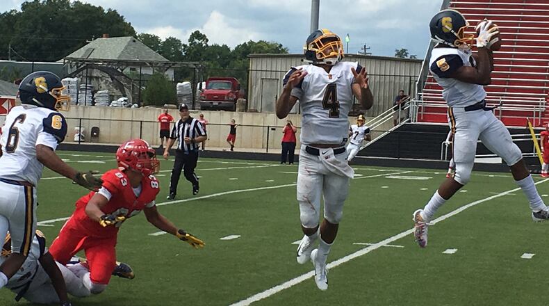 Springfield’s Larry Stephens (5) comes up with a game-clinching interception on pass intended for Fairfield’s Erick All (83) on Saturday afternoon at Fairfield Stadium. That’s Raheim Moss (4) and Jalen Minney (6) also on the play for the Wildcats. RICK CASSANO/STAFF