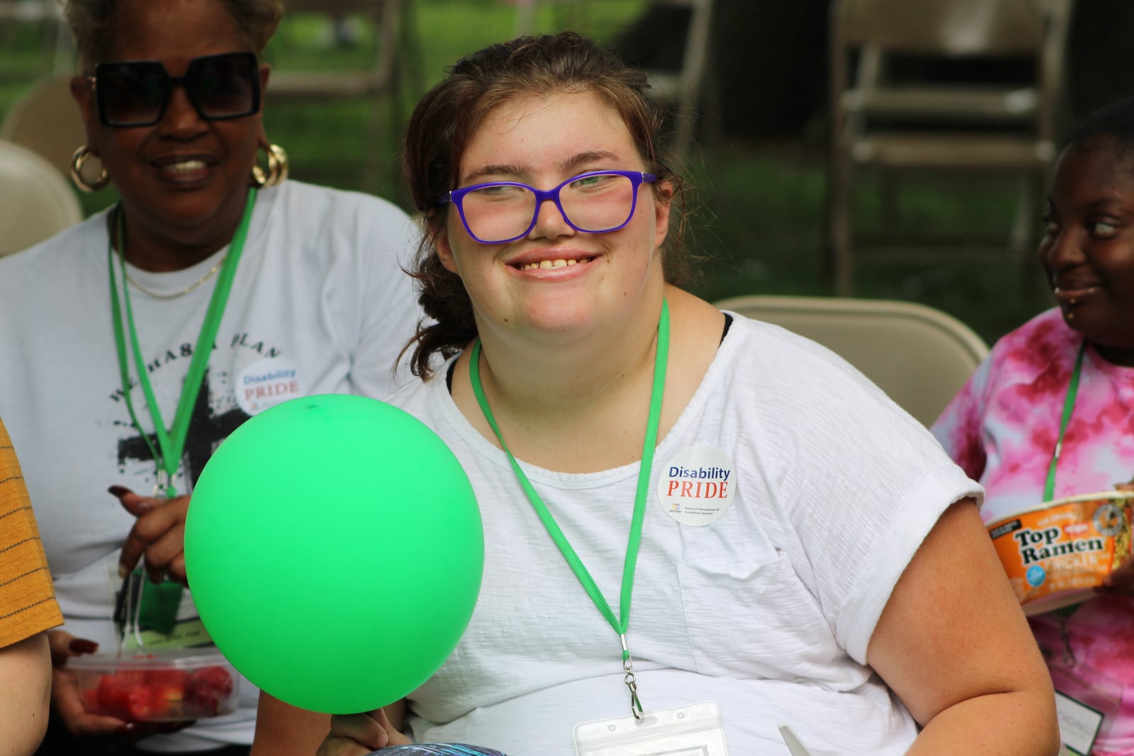 A young woman smiles with her balloon at the Disabilities Pride event in Dayton on Friday, July 25. STAFF/SYDNEY DAWES