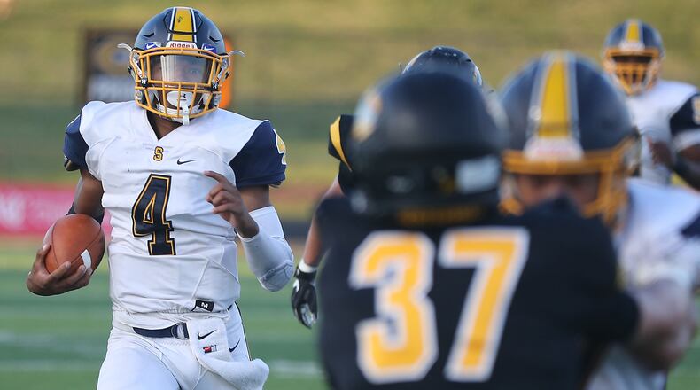 Springfield quarterback Raheim Moss runs for a first down against Centerville. BILL LACKEY/STAFF