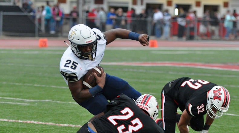 Archbishop Hoban running back Tyris Dickerson is stopped by Wayne defensive back DeAndre Ham during Friday night’s game at Wayne. Nick Dudukovich/CONTRIBUTED