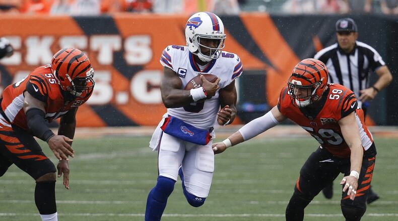 Buffalo Bills quarterback Tyrod Taylor runs the ball against Cincinnati Bengals outside linebacker Nick Vigil in the second half of an NFL football game, Sunday, Oct. 8, 2017, in Cincinnati. (AP Photo/Frank Victores)