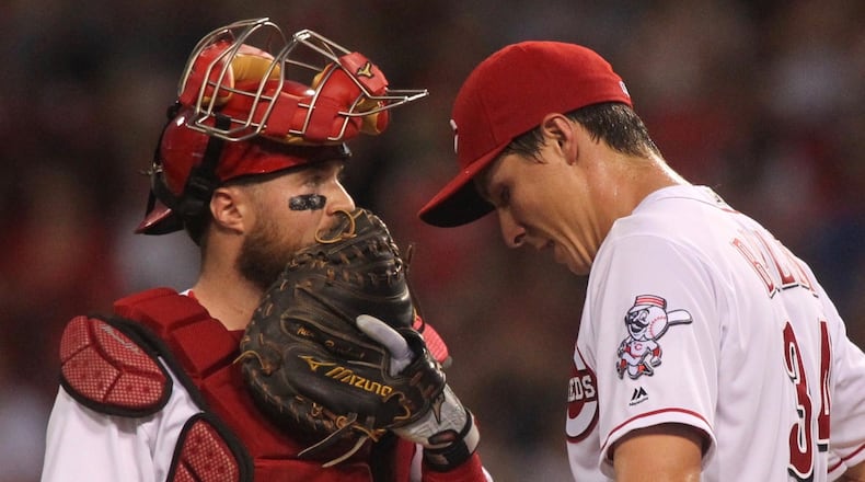Reds catcher Tucker Barnhart and pitcher Homer Bailey talk on the mound during a game against the Marlins on Friday, July 21, 2017, at Great American Ball Park in Cincinnati. David Jablonski/Staff
