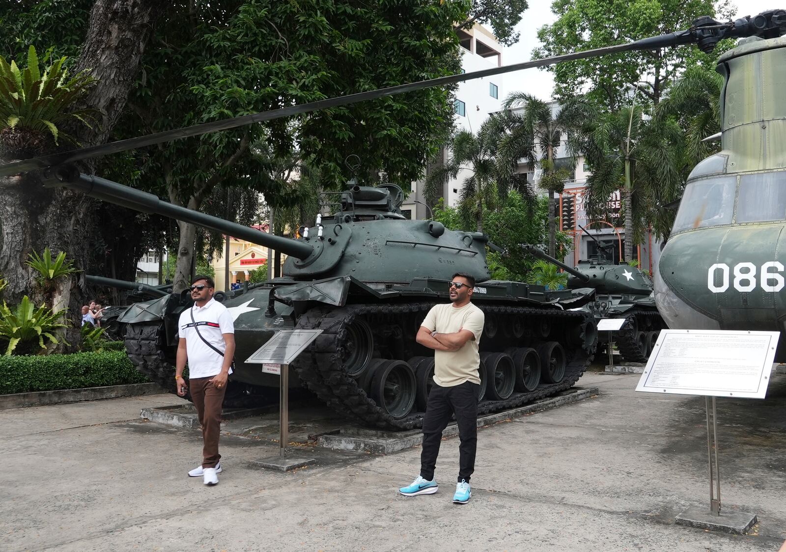 Tourists stand in front of armor combat vehicles on display at the War Remnants Museum in Ho Chi Minh City, Vietnam, Feb. 22, 2025. (AP Photo/Hau Dinh)