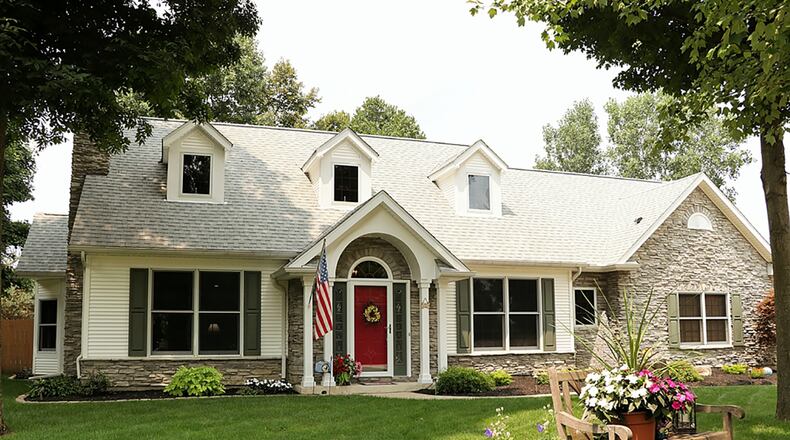 Nestled among the trees at the end of a cul-de-sac, the stone 2-story has an oversized, side-entry garage. The home offers about 2,510 sq. ft. of living space with 3 or 4 bedrooms. CONTRIBUTED PHOTO BY KATHY TYLER