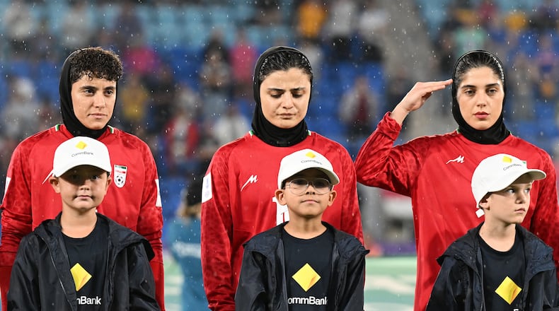 Iran players react during their national anthem ahead of the Women's Asian Cup soccer match between Iran and the Philippines in Robina, Australia, Sunday, March 8, 2026. (Dave Hunt/AAP Image via AP)