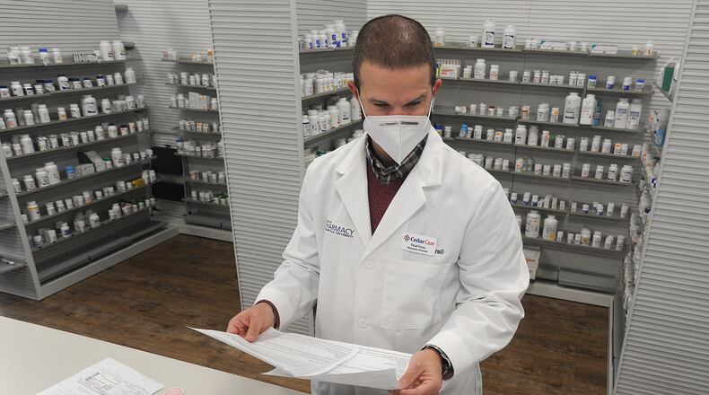 Thad Franz, Director of Pharmacy Services, Cedar Care Village Pharmacy, prepares a prescription Friday. MARSHALL GORBY\STAFF
