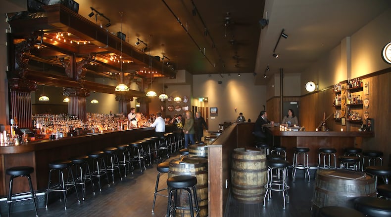 Daytonâs Century Bar has reopened in the three-story former Dayton Power and Light building, 18 S. Jefferson St. The historic cherry wood bar, the centerpiece of the original Century Bar, has been restored and installed in the new expanded space. Century Bar is co-owned by Diane Spitzig and Joseph Head. LISA POWELL / STAFF