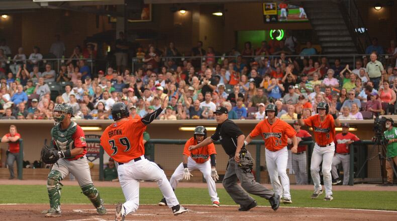 Cassidy Brown scores one of the Dayton Dragons’ runs in a 12-5 Midwest League defeat of the Fort Wayne TinCaps at Fifth Third Field on Friday night. EMILY BRATTON / CONTRIBUTED