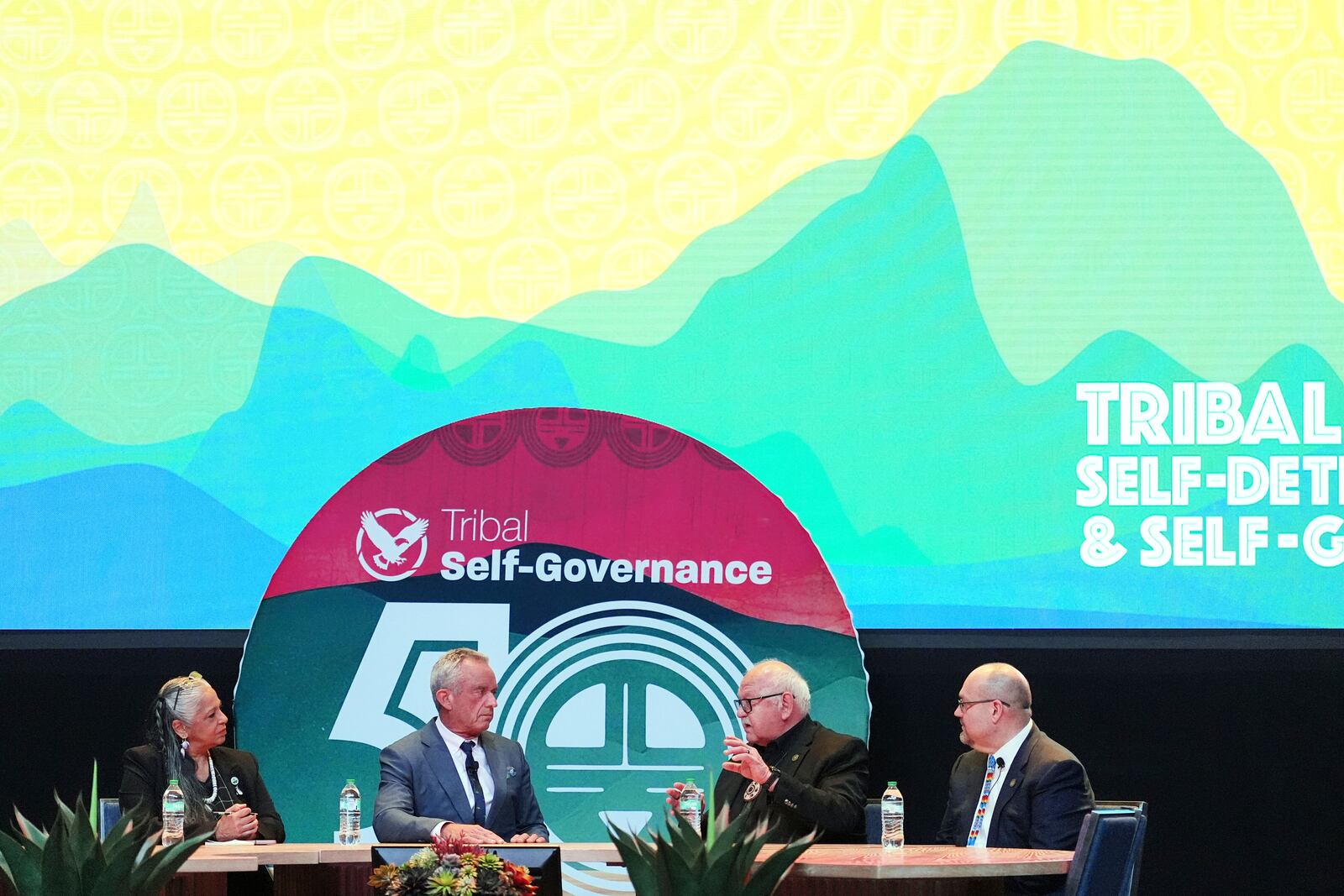 U.S. Health Secretary Robert F. Kennedy Jr., second from left, listens to W. Ron Allen, second from right, Chairman of the Jamestown S'Klallam Tribe, as Cheryl Andrews-Maltais, left, Chairwoman of the Wampanoag Tribe of Gay Head (Aquinnah), and Chris Anoatubby, Lt. Governor of the Chickasaw Nation, during the Fireside Chat at the Tribal Self-Determination and Self-Governance Conference Tuesday, April 8, 2025, in Chandler, Ariz. (AP Photo/Ross D. Franklin)