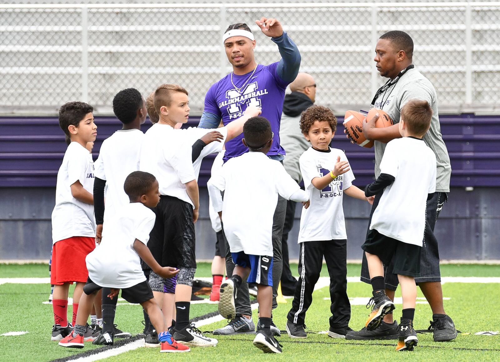 Former Middletown star and current New York Jet receiver Jalin Marshall leads a huddle with area elementary school students during a football camp on Sunday afternoon at Barnitz Stadium. Contributed Photo by Bryant Billing
