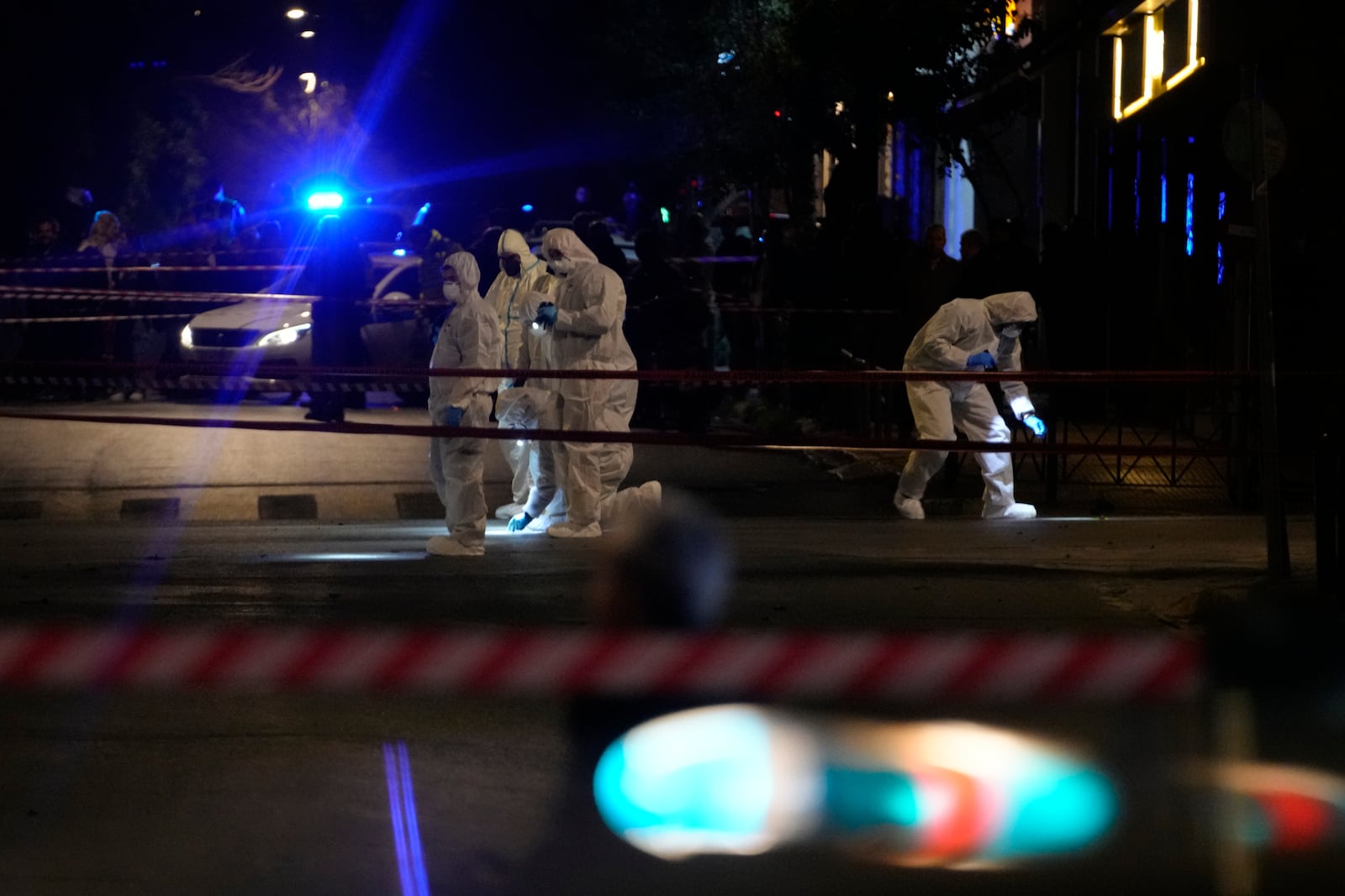 Police officers from the forensics department check the area after a bomb explosion outside of the Hellenic Train offices the company that runs Greece's railway, in Athens, Greece, Friday, April 11, 2025. (AP Photo/Petros Giannakouris)