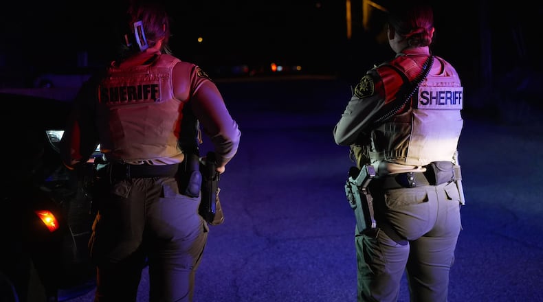 Sheriff's officials block the entrance to a road where a home was being searched in Rio Rico, Arizona, on Tuesday, Feb. 10, 2026, in connection to the investigation of Nancy Guthrie's disappearance. (AP Photo/Ty ONeil)