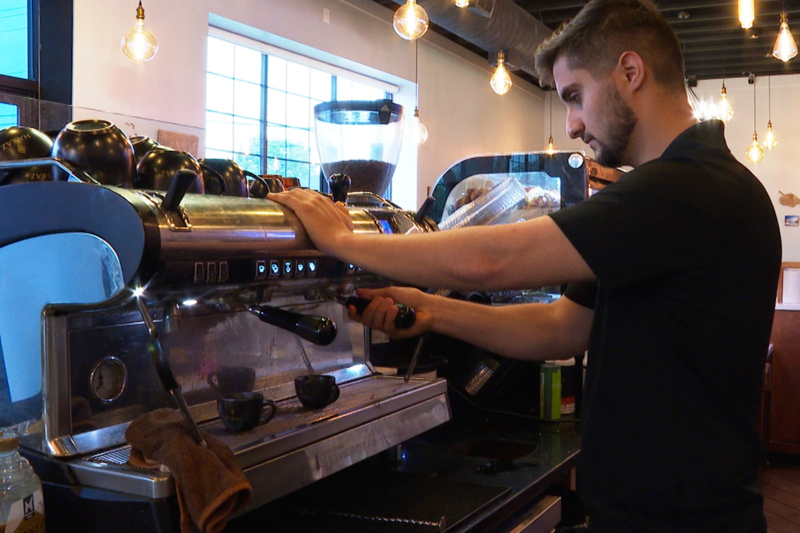 In this image made from video, a Haraz Coffee House employee makes a drink Monday, June 9, 2025, in Dearborn, Mich. (AP Photo/Mike Householder)