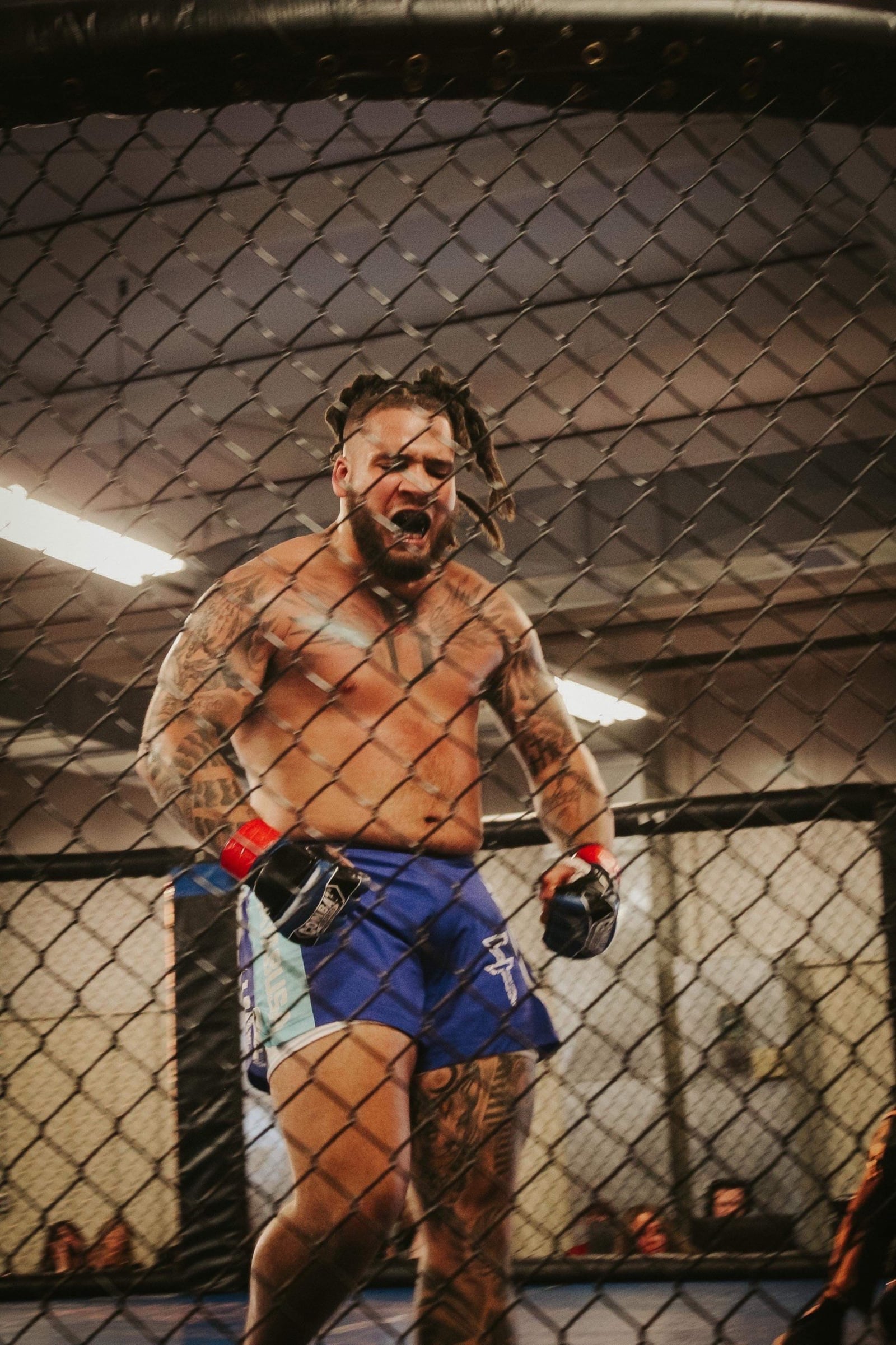 Jerell Lewis of the Fightopia MMA team lets out a victorious roar following his second round TKO victory over Mateo Muniz (Demolition Fight Team from Findlay) in their June EGO Fight Series cage match at the Miami County Fairgrounds in Troy. CONTRIBUTED