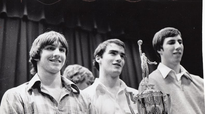 Alter players with the state championship trophy. STAFF FILE