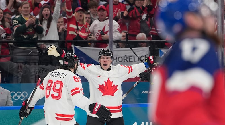 Canada's Bo Horvat, right, celebrates with Canada's Drew Doughty after scoring his sides third goal during a preliminary round match of men's ice hockey between Czech Republic and Canada at the 2026 Winter Olympics, in Milan, Italy, Thursday, Feb. 12, 2026. (AP Photo/Petr David Josek)